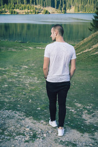 Full length of young man standing on shore