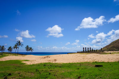 Scenic view of beach against blue sky