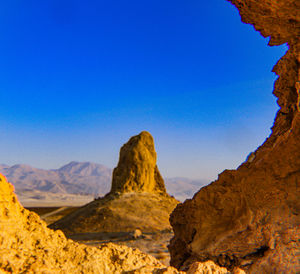 Rock formations in desert against clear blue sky