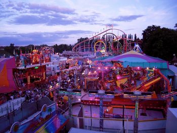 Carousel in amusement park against sky