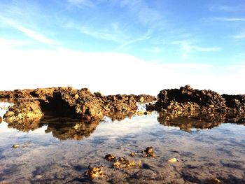 Scenic view of rocks in water against sky