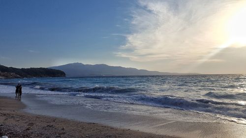 Scenic view of beach against sky during sunset