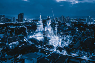 High angle view of city lit up at night