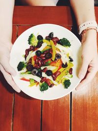 Directly above shot of woman holding food