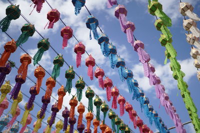 Low angle view of multi colored decorations hanging in row