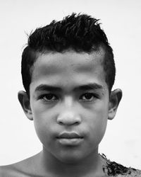 Close-up portrait of young man against white background