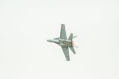 Low angle view of airplane flying against clear sky