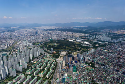 High angle view of illuminated city buildings against sky