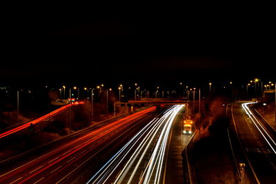 Light trails on railroad tracks at night