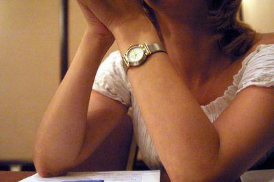 Midsection of woman sitting at home