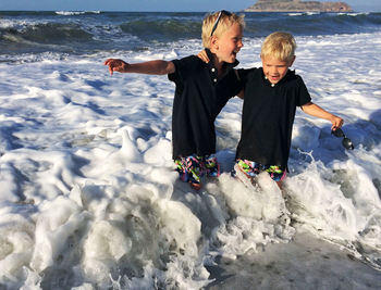 Sibling enjoying in sea