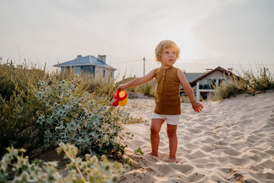 Full length of boy on land against sky