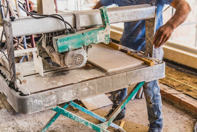 Low section of man working at workshop