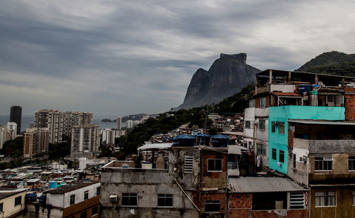 Buildings in city against cloudy sky