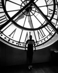 Low angle view of woman standing on ceiling