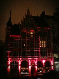 Low angle view of building lit up at night