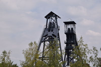 Low angle view of communications tower against sky