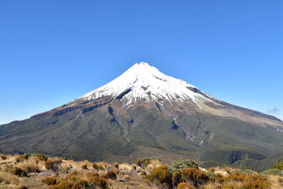 Scenic view of snowcapped mountains against clear blue sky