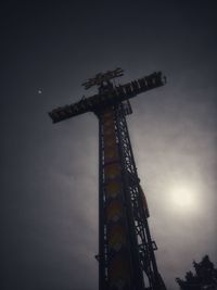 Low angle view of ferris wheel against sky