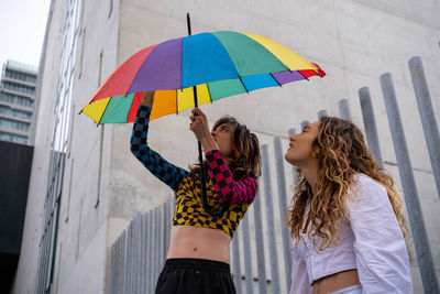 Rear view of woman holding umbrella