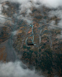 Single ski on lift during foggy autumn day in mountains