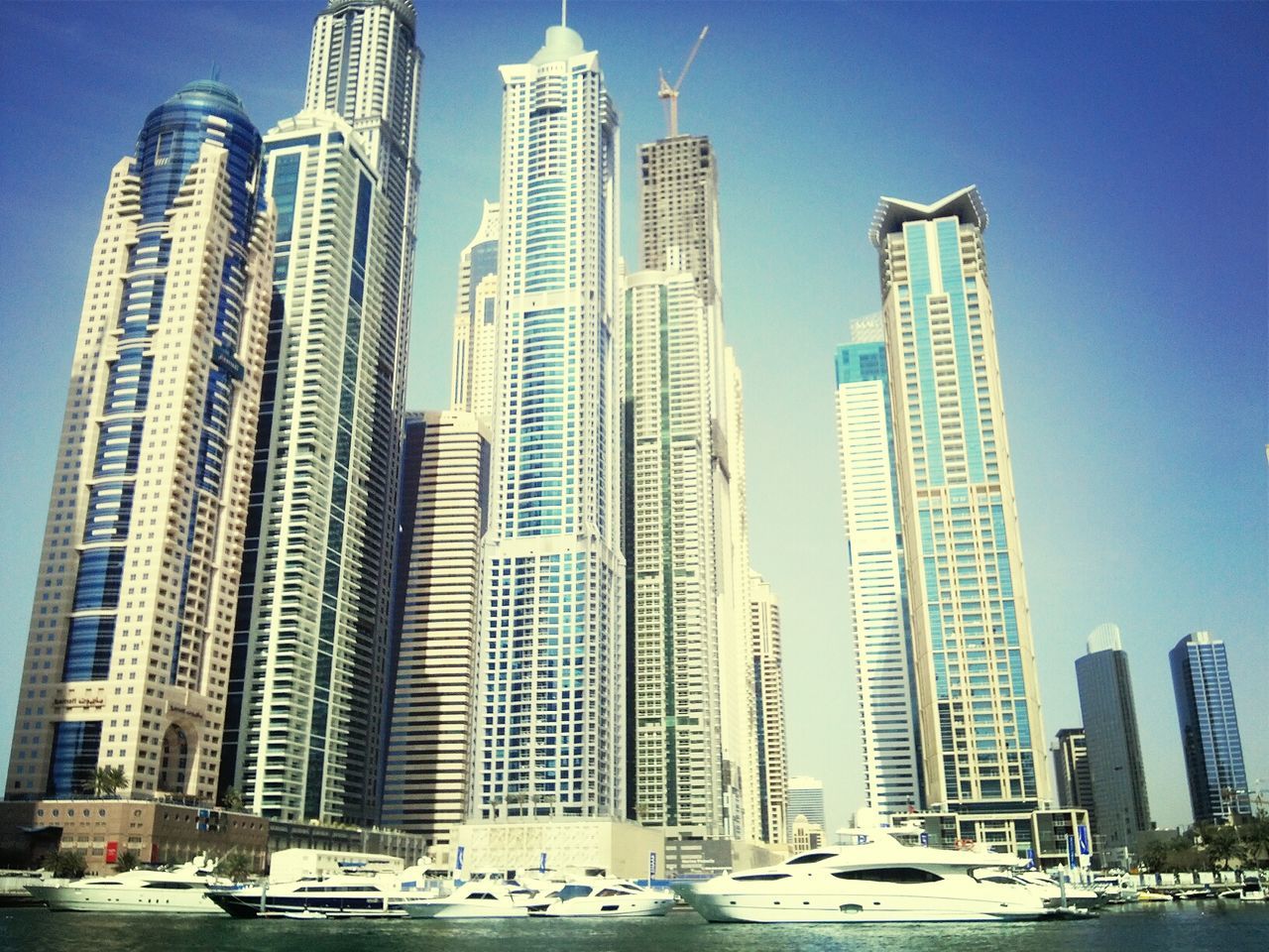 building exterior, skyscraper, architecture, city, built structure, tall - high, modern, office building, tower, urban skyline, financial district, capital cities, blue, cityscape, transportation, clear sky, tall, low angle view, city life, mode of transport