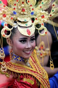 Smiling young woman wearing headdress during festival