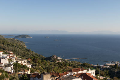 High angle view of townscape by sea against sky