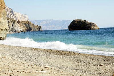 Scenic view of rocks on beach against sky