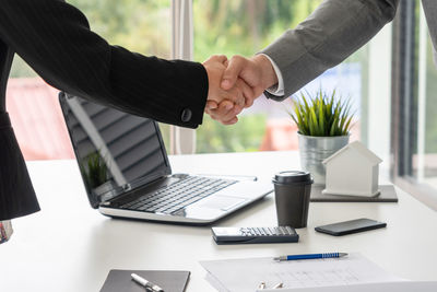 Midsection of businessman people shaking hands