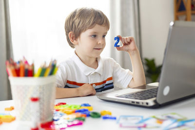 Young woman using laptop at home