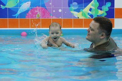 Portrait of smiling boy swimming in pool