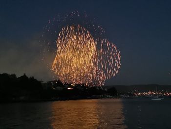 Low angle view of firework display at night