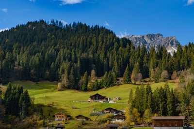 Scenic view of trees and mountains against sky