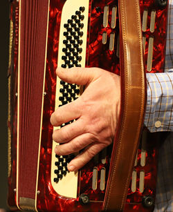 Midsection of man playing accordion