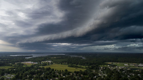 Aerial view of city against cloudy sky