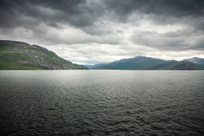 Scenic view of lake and mountains against sky