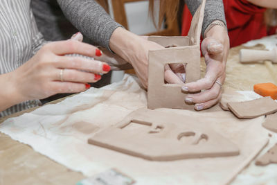 Women's hands knead clay, drawing elements of the product. production of ceramic products. 