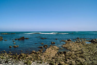 Scenic view of sea against clear blue sky