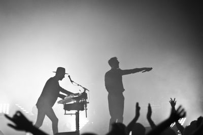 Silhouette people at music concert