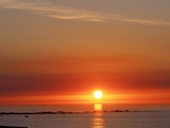 Scenic view of sea against romantic sky at sunset