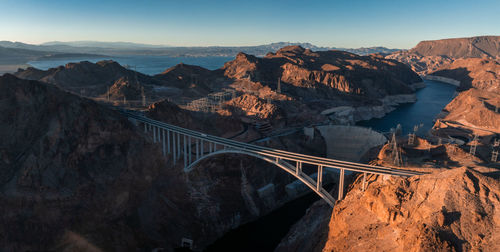 Bridge over mountains against sky