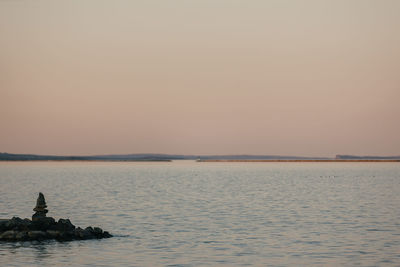 Scenic view of sea against clear sky during sunset