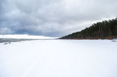 Scenic view of snow covered landscape against sky