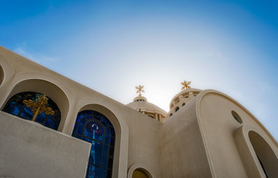 Low angle view of ornate building against blue sky