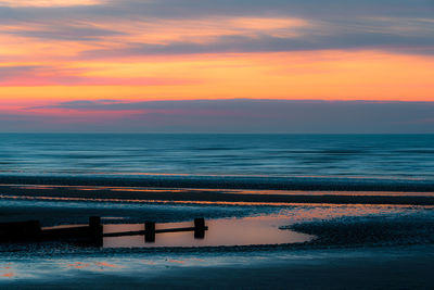 Scenic view of sea against sky during sunrise