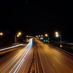 Light trails on road in city at night