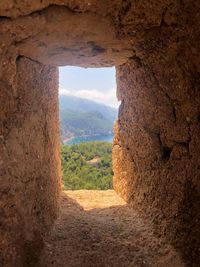 Scenic view of rocky mountains seen through window