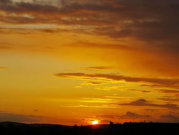 Scenic view of dramatic sky during sunset