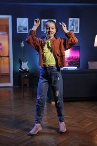 Full length of young woman standing in office